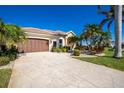 Landscaped property featuring a large driveway and a two-car garage at 1110 Rum Cay Ct, Punta Gorda, FL 33950