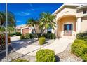 Front entrance with a walkway, landscaping, and a two-car garage at 1110 Rum Cay Ct, Punta Gorda, FL 33950