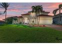 Two-story house with tile roof, manicured lawn, and attached garage at 1245 Whippoorwill Ct, Punta Gorda, FL 33950