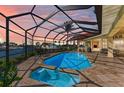 Enclosed pool and spa area with canal views at 1245 Whippoorwill Ct, Punta Gorda, FL 33950