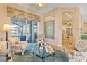 Spacious living room with floral armchairs and glass-top table at 13761 Long Lake Ln, Port Charlotte, FL 33953