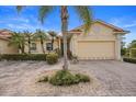 Tan house with a two-car garage and palm trees at 1531 Aqui Esta Dr # 1, Punta Gorda, FL 33950