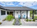 Inviting front porch with stylish seating and landscaping at 1573 Faraday St, Port Charlotte, FL 33952