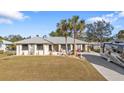 Single-story home with RV parking and palm trees at 18266 Grace Ave, Port Charlotte, FL 33948