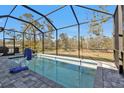 Enclosed pool area with a spacious deck and a surrounding fence at 18322 Garman Ave, Port Charlotte, FL 33948