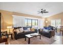 Living room with two sofas, a coffee table, and a ceiling fan at 1839 Settlers Dr # B-6, Nokomis, FL 34275