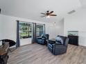 Living room with hardwood floors, a fish tank and two black recliners at 2529 Flagami Ln, North Port, FL 34286