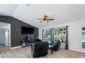 Bright living room featuring hardwood floors, large windows, and comfortable seating at 2529 Flagami Ln, North Port, FL 34286