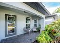 Inviting front porch with seating area, perfect for relaxing and enjoying the Florida sunshine at 25896 Prada Dr, Punta Gorda, FL 33955