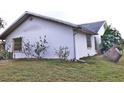 Side view of a house showing a window and landscaping at 27446 Pasto Dr, Punta Gorda, FL 33983