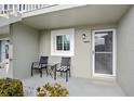 Condo front entry with seating area and storm door at 3310 Loveland Blvd # 1604, Punta Gorda, FL 33980