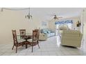 Living room with light blue couch and wicker dining set at 3310 Loveland Blvd # 1604, Punta Gorda, FL 33980