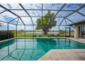 Inviting screened pool with a view of a lake and golf course at 3723 Tripoli Blvd, Punta Gorda, FL 33950