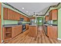 Spacious kitchen with an island, stainless steel appliances, and wood-look flooring at 4107 Rock Creek Dr, Port Charlotte, FL 33948