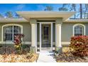 Inviting front entrance with columns and a screened door at 4198 Kinlock St, North Port, FL 34286