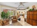 Living room with a view into Gathering room and access to the backyard at 4258 Mermell Cir, North Port, FL 34291