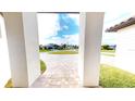 View from entryway of paved driveway and neighborhood at 432 Gun Cay Ln, Punta Gorda, FL 33950