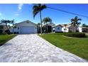 House exterior showing a paved driveway and manicured lawn at 506 Monaco Dr, Punta Gorda, FL 33950