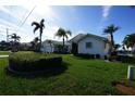 Side view of a house with lush landscaping and palm trees at 506 Monaco Dr, Punta Gorda, FL 33950