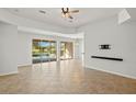 Bright living room with tile floors and sliding doors to the pool area at 5625 Whispering Oaks Dr, North Port, FL 34287