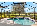 Relaxing screened pool and spa with a waterfall feature at 5625 Whispering Oaks Dr, North Port, FL 34287