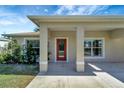 Covered porch with a red door and white columns at 6174 Alloway St, Englewood, FL 34224