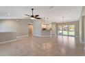 Open floor plan living area with tile floors and high ceilings at 6174 Alloway St, Englewood, FL 34224