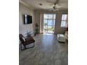 Living room with lake view, tile floors, and comfy seating at 8773 Tuscany Isles Dr, Punta Gorda, FL 33950