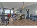 Living room with hardwood floors, comfortable seating, and water views at 900 E Marion Ave # 1301, Punta Gorda, FL 33950