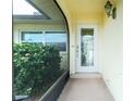 Front door entrance with a glass door and screened porch at 109 Peckham Se St, Port Charlotte, FL 33952