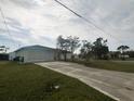 Home's exterior showcasing a two-car garage and a long driveway at 12143 & 12151 Dubarry Ave, Port Charlotte, FL 33981