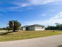 Property's exterior view, showcasing the home's side and street view at 12143 & 12151 Dubarry Ave, Port Charlotte, FL 33981