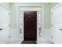 Elegant entryway with a dark wood door and sidelights at 13204 Kakapo Ave, Port Charlotte, FL 33981