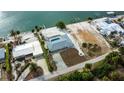 Bird's eye view of waterfront property, showcasing the home and surroundings at 1350 Aqua View Ln, Englewood, FL 34223