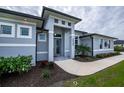 Modern house exterior with gray walls and landscaping at 15308 Acorn Cir, Port Charlotte, FL 33981