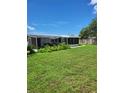 Spacious backyard with screened patio and fenced yard at 158 Concord Ne Dr, Port Charlotte, FL 33952