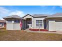 One-story home with light-colored exterior and manicured lawn at 17220 Horizon Ln, Port Charlotte, FL 33948