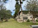 Complex with grassy area, picnic tables, and BBQ at 19505 Quesada Ave # Rr203, Port Charlotte, FL 33948