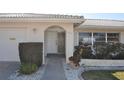 Inviting front entrance with landscaping, walkway, and two-car garage at 2171 Bayou Rd, Punta Gorda, FL 33950