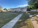 House exterior showcasing a well-maintained lawn and walkway at 21921 Beverly Ave, Port Charlotte, FL 33952