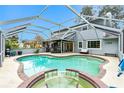 Relaxing kidney-shaped pool with a spa and screened enclosure at 238 Woodingham Trl, Venice, FL 34292