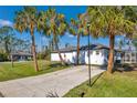 Large side yard with spacious driveway and mature landscaping at 2418 Frantz St, North Port, FL 34286