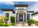 Front entrance with gray columns and double doors at 2730 Rio Ct, Punta Gorda, FL 33950