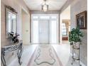 Elegant entryway with tiled floor, ornate mirror, and access to other rooms at 2856 Deborah Dr, Punta Gorda, FL 33950