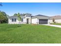 Modern two-story home with landscaping and driveway at 3334 Levee St, North Port, FL 34288