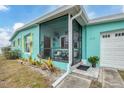 Inviting screened porch with wicker chairs, offering a relaxing outdoor space at 4118 Gardner Dr, Port Charlotte, FL 33952