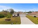 Single-story house with a two-car garage and landscaped lawn at 4465 Kaskin Ave, North Port, FL 34286