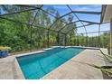 Inviting screened-in pool with a tiled deck at 5208 Griggs Ave, North Port, FL 34291