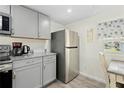 Modern kitchen with stainless steel appliances and gray cabinets at 5298 Palena Blvd, North Port, FL 34287