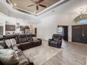 Open concept living room showcasing a sectional sofa and views into the kitchen at 5870 Hornbuckle Blvd, North Port, FL 34291